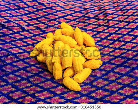 Close up silkworm cocoon on messaline stock photo