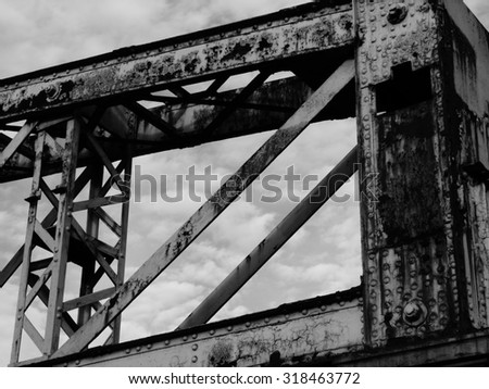 rusted metal structure rail transport train sky clouds