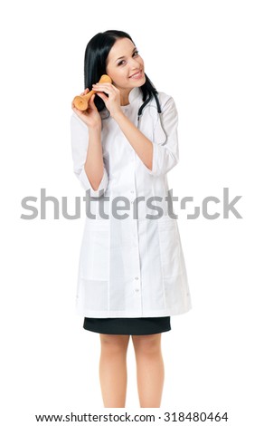 Female doctor holding a wooden stethoscope for listening to baby heart sound, isolated on white background