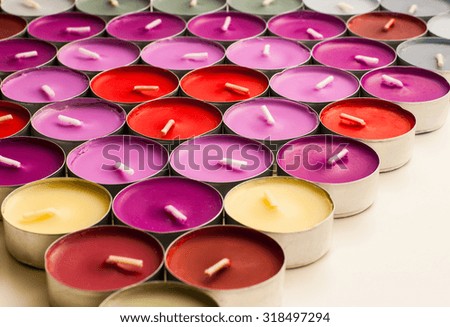Various Colors of Tea Candles Arranged to Triangle Shape