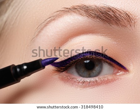Closeup fashion makeup. Perfect face skin,  extreme long eyelashes and blue arrow make up. Retro make-up. Royalty-Free Stock Photo #318498410