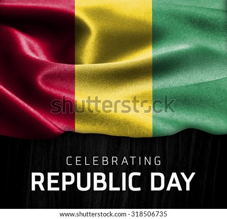 Guinea flag and Celebrating Republic Day Typography on wood background