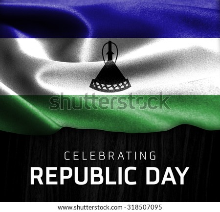 Lesotho flag and Celebrating Republic Day Typography on wood background