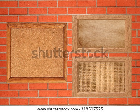 empty wooden frames on the red brick wall