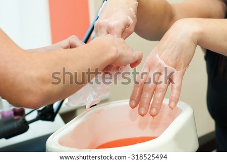 paraffin treatment for the woman customer in beauty salon Royalty-Free Stock Photo #318525494
