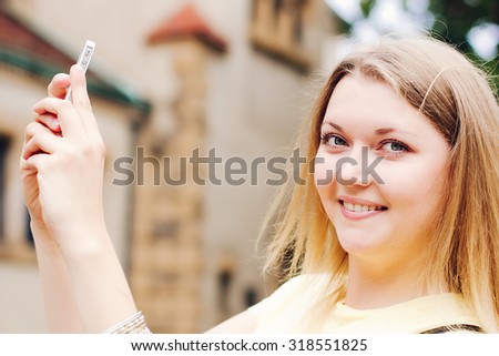 Girl traveler taking photo on her phone