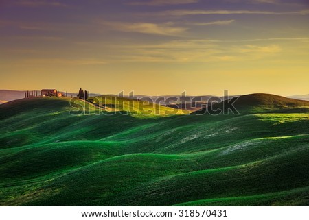 Tuscany, rural landscape in Crete Senesi land. Rolling hills, countryside farm, cypresses trees, green field on warm sunset. Siena, Italy, Europe. Royalty-Free Stock Photo #318570431