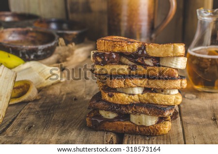 French toast filled banana and chocolate, rustic picture, place for your advertising, beer behind on scene
