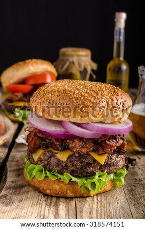 American rustic bacon burger with cheddar, beef, salad and vegetable, old school picture, with czech beer, place for advertising