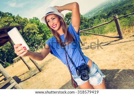 Young beautiful woman standing by viewpoint and taking selfie for memory from summer travel vacation.