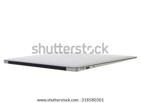 New high-speed thin light silver aluminium laptop computer notebook side closed with open slots isolated on a white background