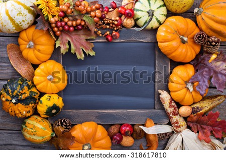 Pumpkins and variety of squash around a chalkboard