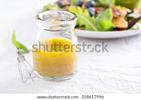 Salad dressing with olive oil, honey, mustard and vinegar Royalty-Free Stock Photo #318617996
