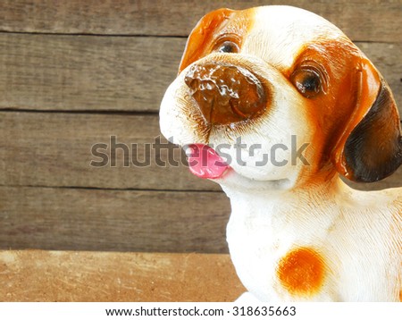 ceramic welcome dog on wooden background still life