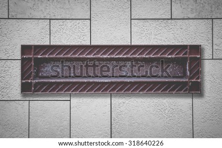 Old style letterbox and concrete wall background