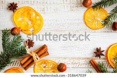 Christmas decoration with fir branches,star anise,cinnamon stick,nuts and slices of dried oranges.