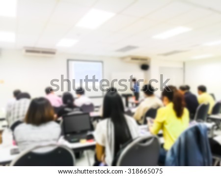 Blur behind student or collegian study lecture in classroom with notebook and screen projector in bachelor or master or Ph.D. degree in university college or business seminar or business meeting Royalty-Free Stock Photo #318665075