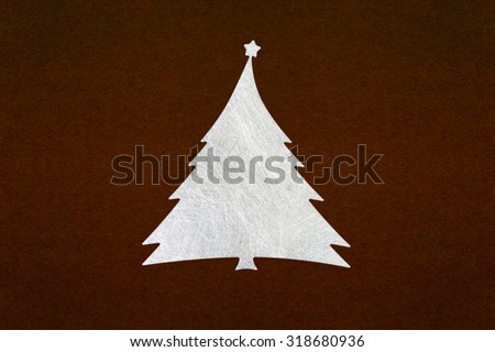 silver fiber christmas tree on dark brown paper texture