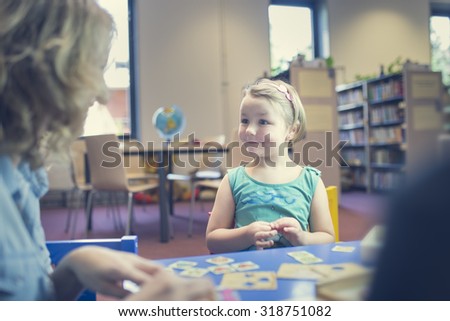 Portrait of couple of kids in classroom, playing and educating