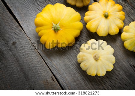 Autumn yellow squashes on old boards
