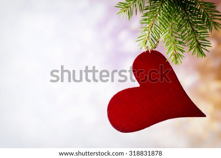 Spruce branch with Christmas decorations on a gray background.