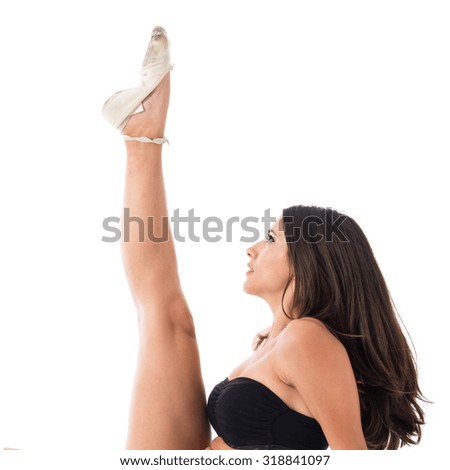 Young ballet dancer posing over white background