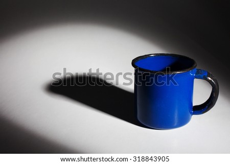Blue Metal mug isolated on white background with a shadow.
