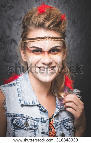 American Indian with paint face camouflage - studio photo with professional makeup