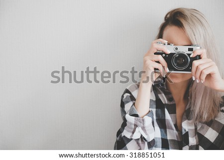 Soft photo of woman in checkered shirt making a picture
