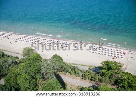 Pictures from the air. Bay with a beach, garden, shade the leaf against the blue sea