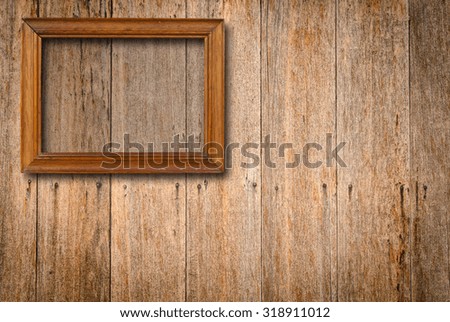 Wooden frame for picture on old brown wooden board background with clipping path