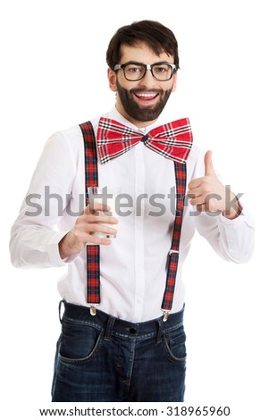 Funny man wearing suspenders with ok sign and glass of milk.