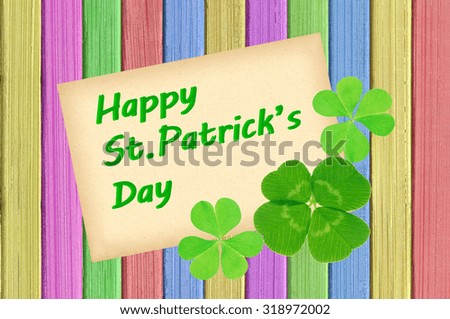 Happy St Patrick's Day card on painted color wooden texture close-up