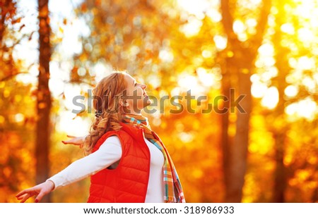 happy girl enjoying life and freedom in the autumn on the nature Royalty-Free Stock Photo #318986933