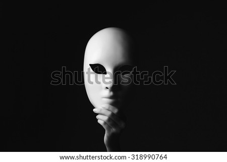 mask in hand.halloween concept Royalty-Free Stock Photo #318990764