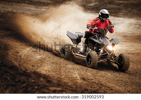 ATV rider in the action Royalty-Free Stock Photo #319002593