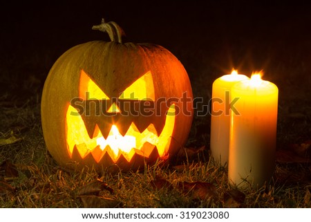 Halloween pumpkins with candles on black background