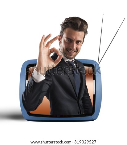 Smiling man comes out of vintage TV