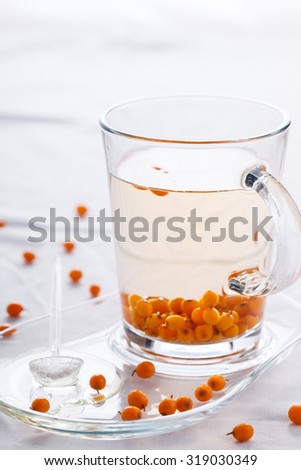 Tea with sea buckthorn and honey, in a glass Cup.selective focus