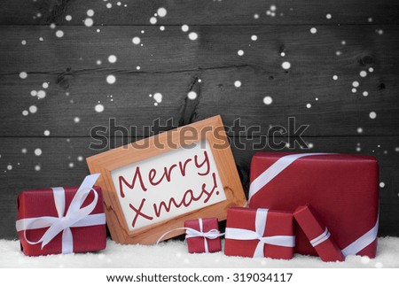 Red Christmas Decoration On Snow, Snowflakes, Christmas Gifts, Presents. Brown, Picture Frame With English Text Merry Xmas. Rustic, Vintage Gray Wooden Background. Black And White Image
