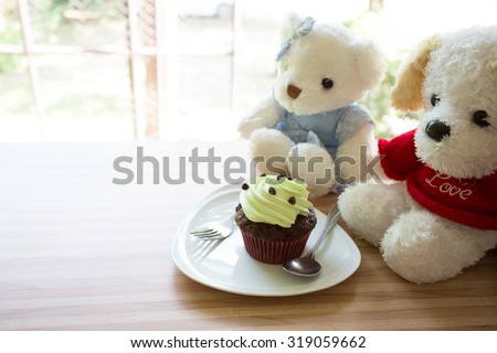 cup cake on wooden table in coffee shop.