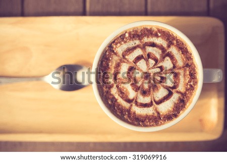 Latte Coffee art on the wooden desk vintage color