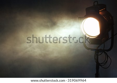 theater spot light with smoke against grunge wall Royalty-Free Stock Photo #319069964