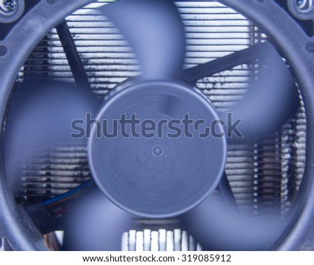 Close up of black computer fan, with motion blur on blades