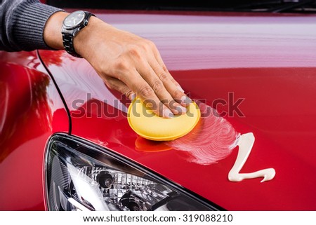 car care, polishing the red car Royalty-Free Stock Photo #319088210