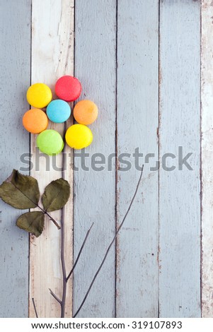 idea colorful sweet macaroons as a flower with vintage blue and white wood background 