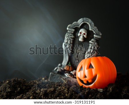 Halloween night scene with pumpkin buckets and RIP tombstone