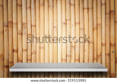 Empty top of natural stone shelves and bamboo wall background. For product display