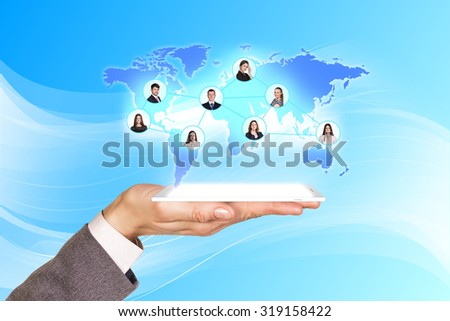 Mans hand holds the phone with projection on the blue background. Elements of this image furnished by NASA