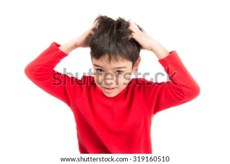 Little boy itchy his hair on white background